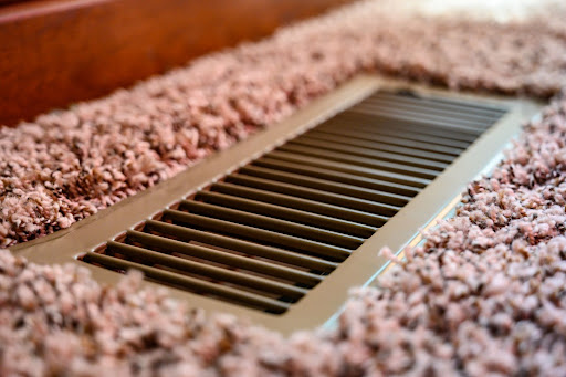 air vent surrounded by pink carpet