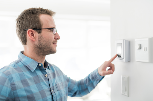 man using thermostat