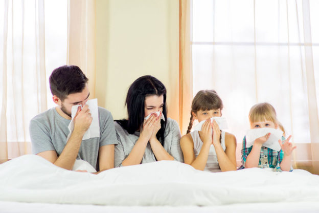 A family all using tissues, experiencing allergies